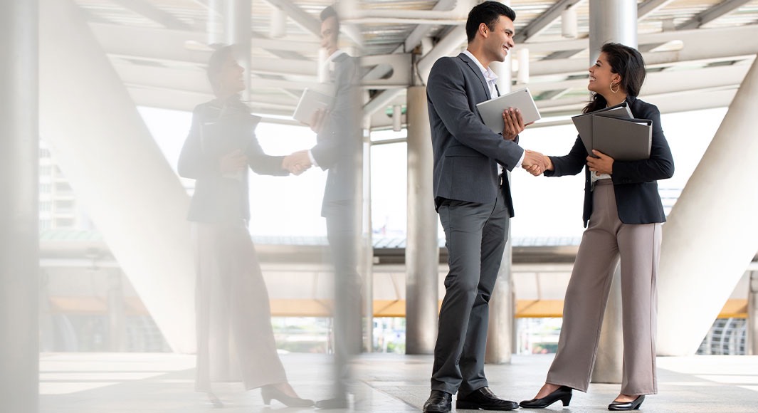 A business woman and man shaking hands